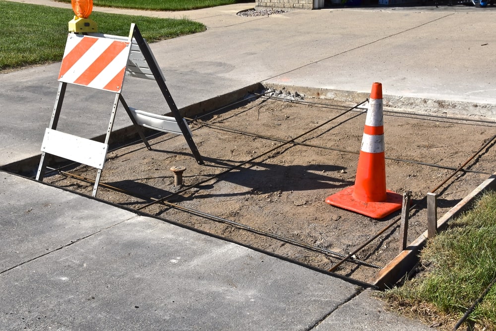 Columbus, OH driveway showing measured crack and repaired panel next to new concrete