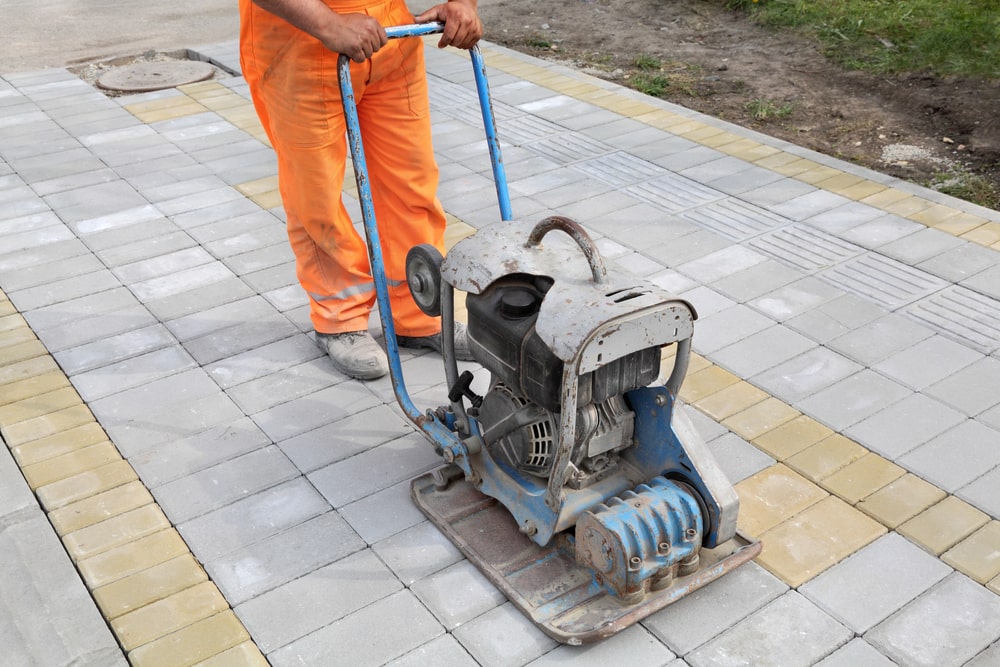 Applying penetrating sealer to a Columbus, OH concrete driveway after winter cleanup